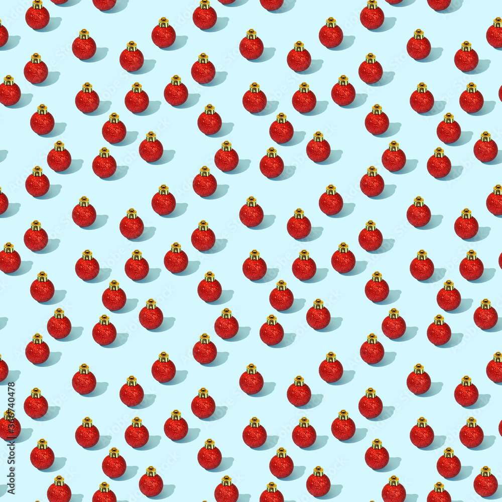 Christmas toys for the New Year tree. Red shiny balls on a bright blue background in a pattern. Celebrating the winter holiday. Holiday party decoration. Christmas toys for the New Year tree. Red shiny balls on a bright blue background in a pattern. Celebrating the winter holiday. Holiday party decoration.