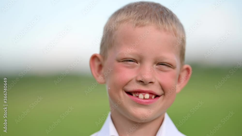 Portrait of a Funny Boy in Outdoors. Happy Child Smiling Looking Camera