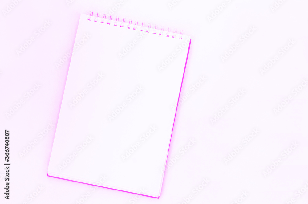 creative process. blank sheet of spiral notebook, cup of coffee on a pink background. creative process. blank sheet of spiral notebook, cup of coffee on a pink background.