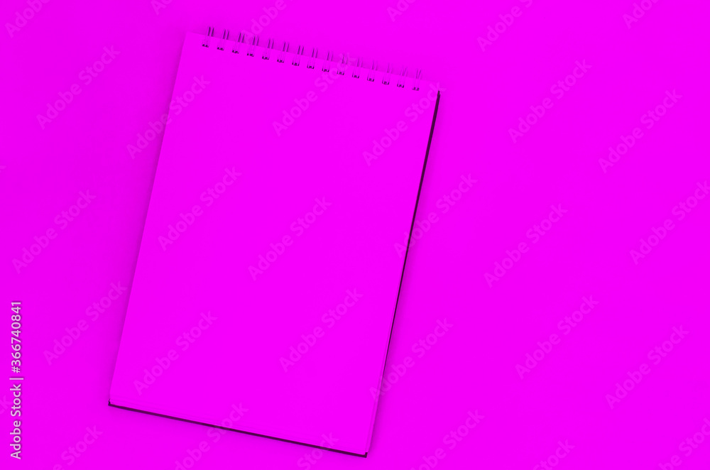 creative process. pink blank sheet of spiral notebook, cup of coffee on a pink background. creative process. pink blank sheet of spiral notebook, cup of coffee on a pink background.
