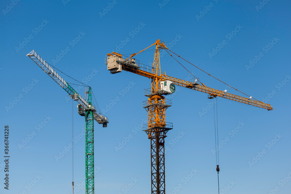tower cranes on a background of blue sky a tower cranes on a background of blue sky a