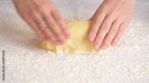 women's hands roll out the dough into dumplings, cuts out round pieces of dough with a glass.