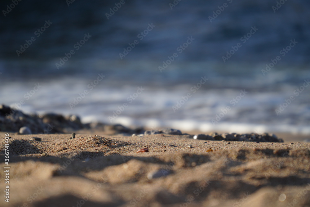 Closeup of sand and pebble on beach during summer afternoon Closeup of sand and pebble on beach during summer afternoon