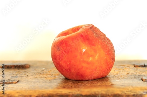 apple on a wooden table. rotten apple image