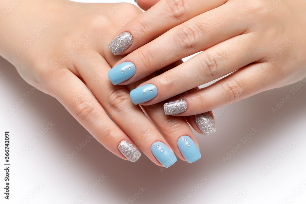 blue manicure with silver glitter and crystals on short square nails blue manicure with silver glitter and crystals on short square nails