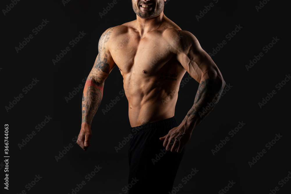 Close up body strong man. Bodybuilder on black background.