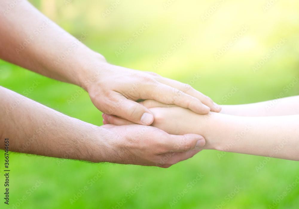 Father male hands holding child hands