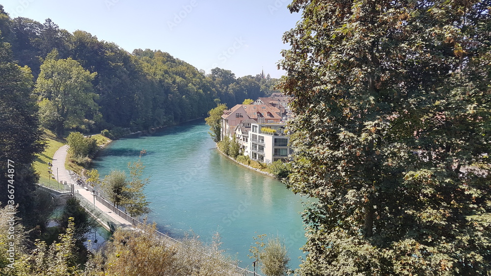 view of the Aare river with buildings and green lake color in Bern, Switzerland