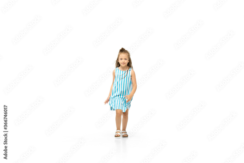 Happy child, little and emotional caucasian girl jumping and running isolated on white background. Looks happy, cheerful, sincere. Copyspace for ad. Childhood, education, happiness concept. Happy child, little and emotional caucasian girl jumping and running isolated on white background. Looks happy, cheerful, sincere. Copyspace for ad. Childhood, education, happiness concept.