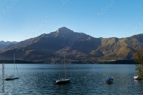 placid lake with sailing boat and blue sky