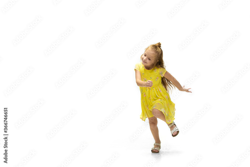Happy child, little and emotional caucasian girl jumping and running isolated on white background. Looks happy, cheerful, sincere. Copyspace for ad. Childhood, education, happiness concept. Happy child, little and emotional caucasian girl jumping and running isolated on white background. Looks happy, cheerful, sincere. Copyspace for ad. Childhood, education, happiness concept.
