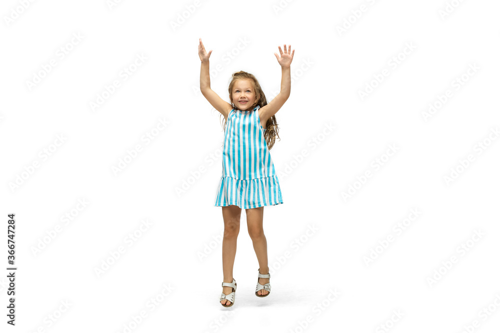 Happy child, little and emotional caucasian girl jumping and running isolated on white background. Looks happy, cheerful, sincere. Copyspace for ad. Childhood, education, happiness concept. Happy child, little and emotional caucasian girl jumping and running isolated on white background. Looks happy, cheerful, sincere. Copyspace for ad. Childhood, education, happiness concept.