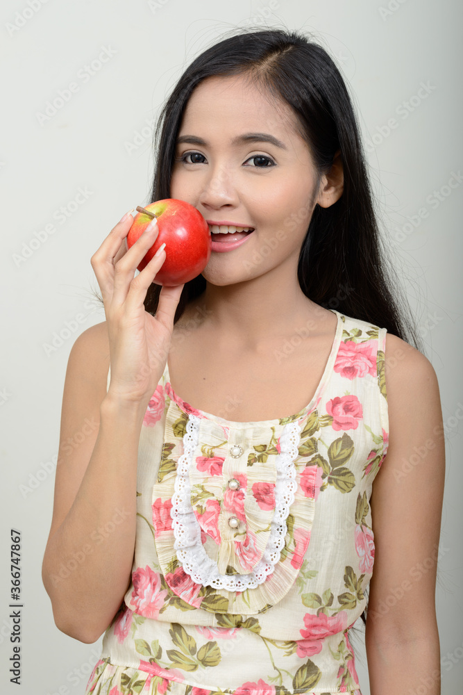 Portrait of happy young beautiful Asian woman