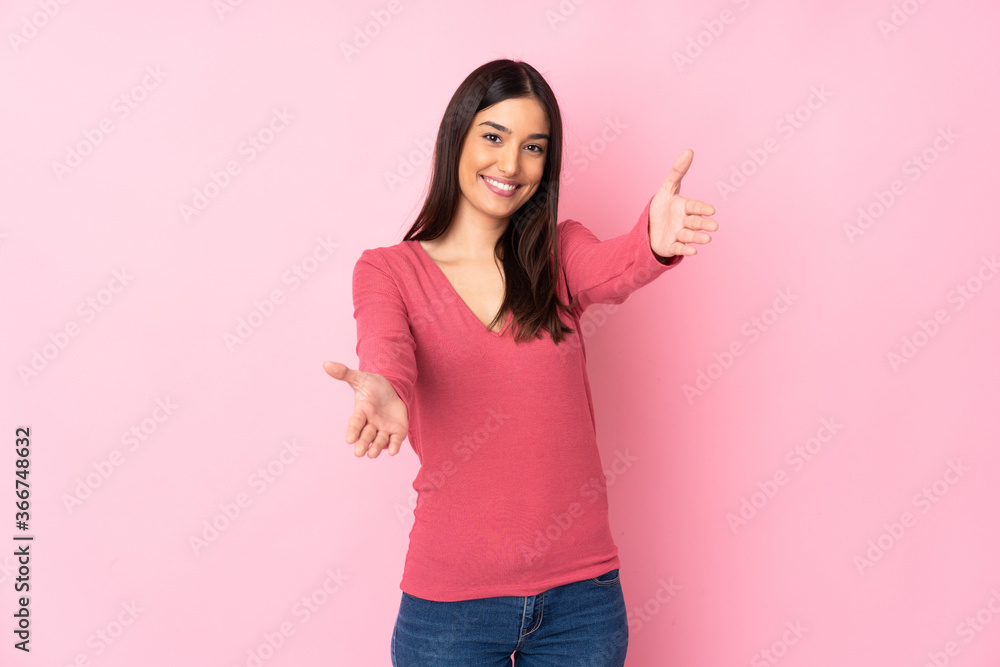 Young caucasian woman over isolated background presenting and inviting to come with hand Young caucasian woman over isolated background presenting and inviting to come with hand