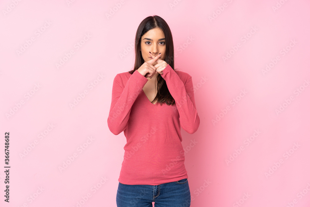 Young caucasian woman over isolated background showing a sign of silence gesture Young caucasian woman over isolated background showing a sign of silence gesture