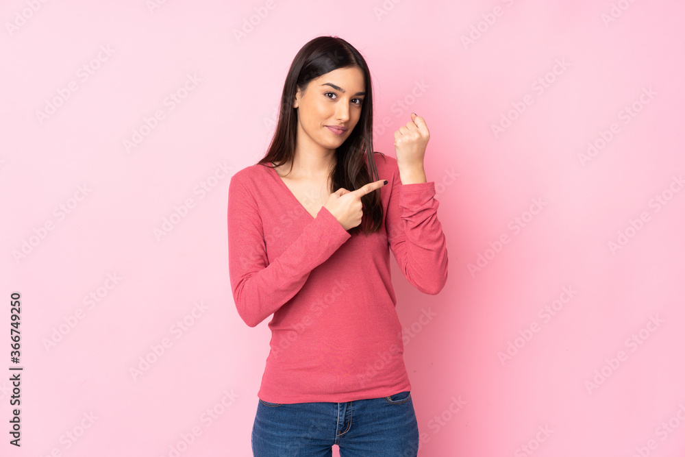 Young caucasian woman over isolated background making the gesture of being late Young caucasian woman over isolated background making the gesture of being late