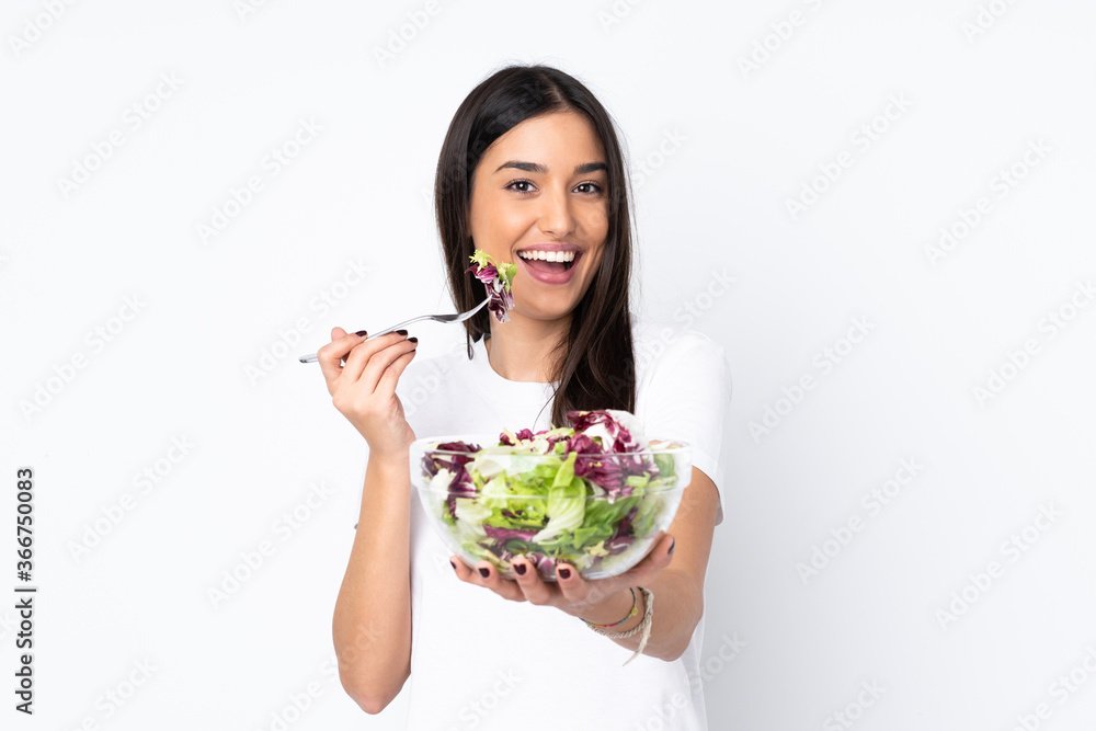 Young woman with salad isolated on white background Young woman with salad isolated on white background