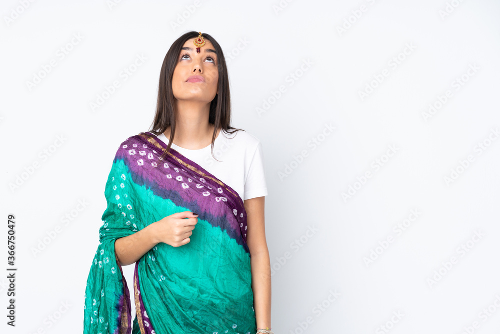 Young Indian woman isolated on white background and looking up Young Indian woman isolated on white background and looking up