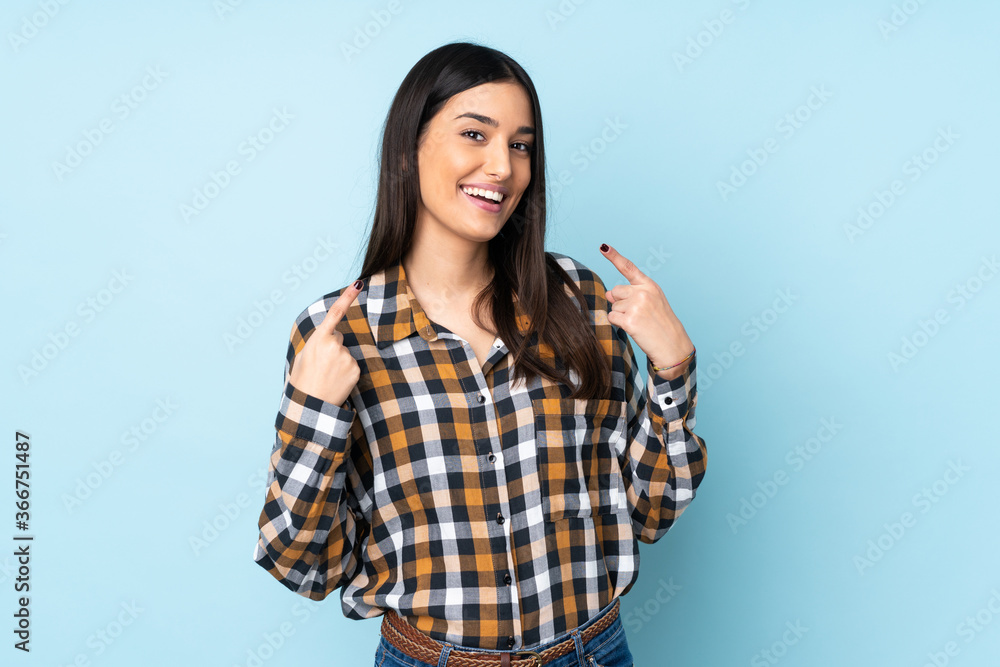 Young caucasian woman isolated on blue background giving a thumbs up gesture Young caucasian woman isolated on blue background giving a thumbs up gesture