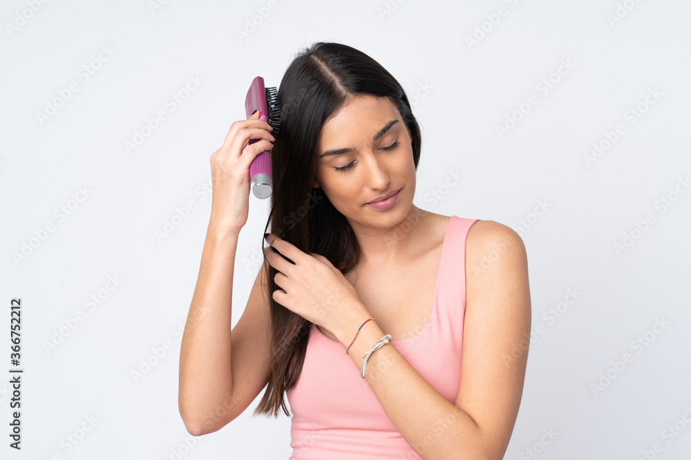 Young caucasian woman isolated on white background with hair comb Young caucasian woman isolated on white background with hair comb