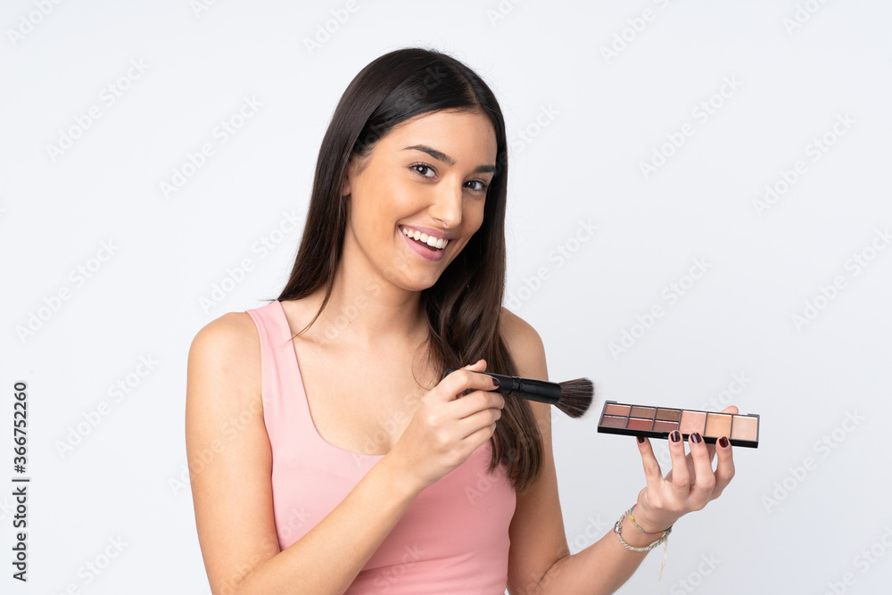Young caucasian woman isolated on white background with makeup palette and happy Young caucasian woman isolated on white background with makeup palette and happy