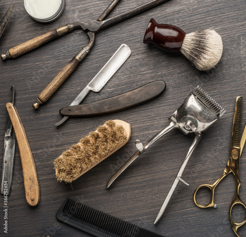 Classic grooming and hairdressing tools on wooden background.