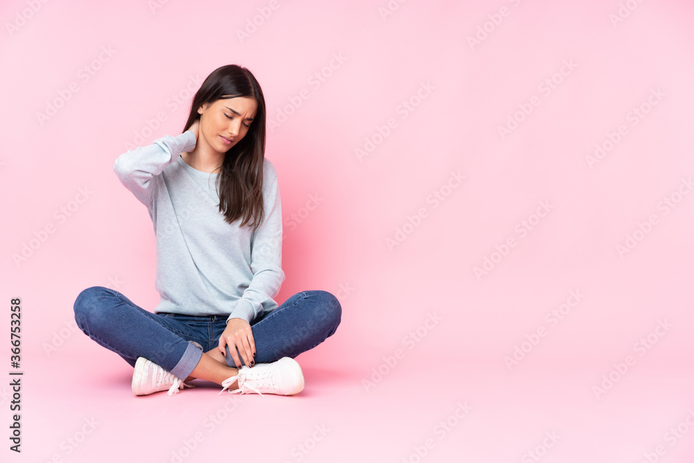 Young caucasian woman isolated on pink background with neckache Young caucasian woman isolated on pink background with neckache