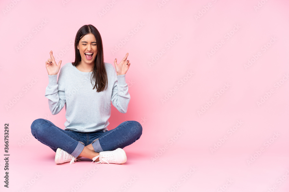 Young caucasian woman isolated on pink background with fingers crossing Young caucasian woman isolated on pink background with fingers crossing