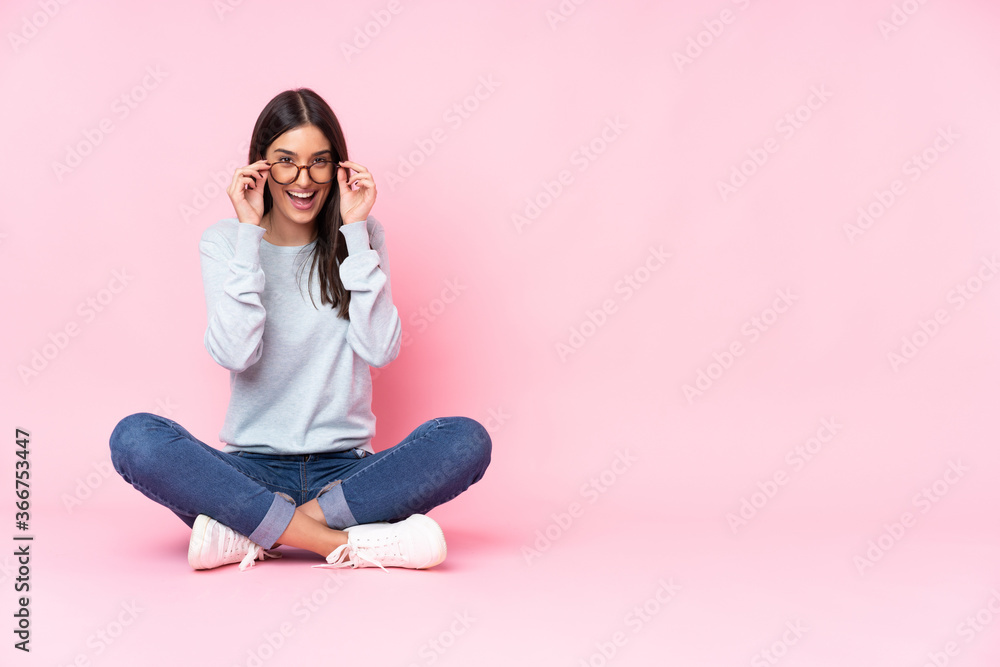 Young caucasian woman isolated on pink background with glasses and surprised Young caucasian woman isolated on pink background with glasses and surprised