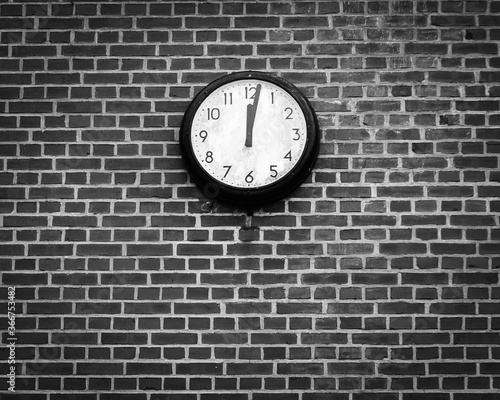 Old clock on brick wall 