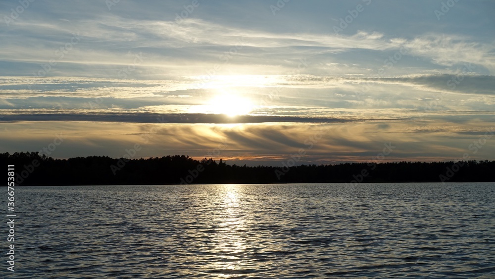 Naklejka premium the clouds during sunset over a Scandinavian lake