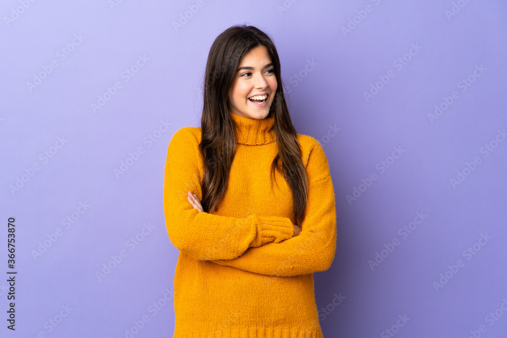 Teenager Brazilian girl over isolated purple background happy and smiling Teenager Brazilian girl over isolated purple background happy and smiling