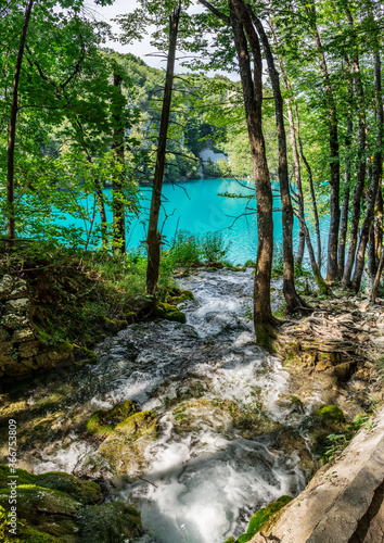 Plitvice Lakes National Park is one of the oldest and largest national parks in Croatia and UNESCO World Heritage. Waterfalls  lake and green rocky hills inside the park. Travelling around Europe.