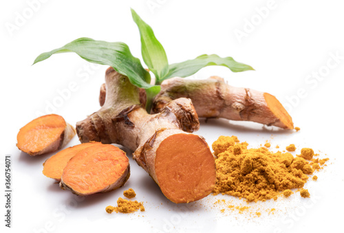 Fresh turmeric rhizome and turmeric powder isolated on white background.