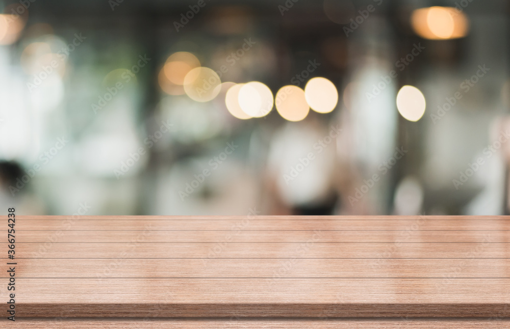 Empty wooden table top with lights bokeh on blur restaurant background Empty wooden table top with lights bokeh on blur restaurant background
