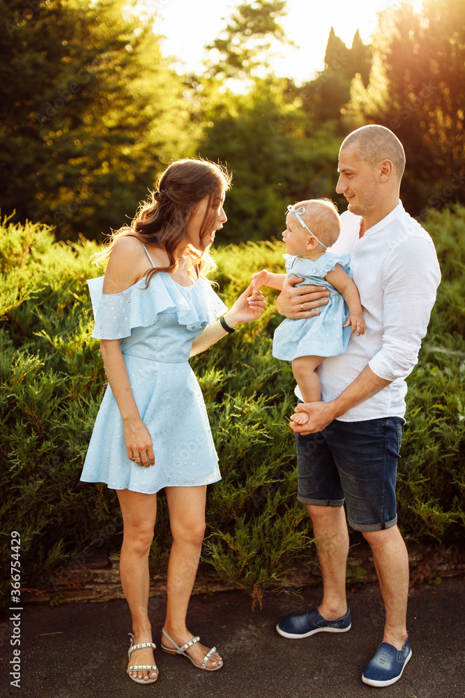 Obraz premium Loving overjoyed parents hold their adorable daughter