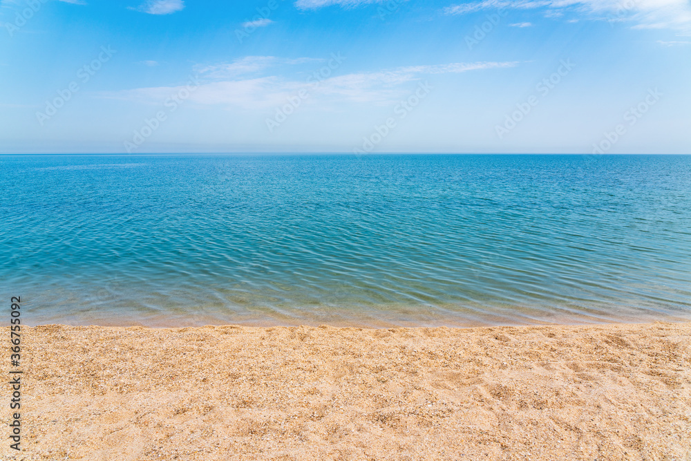 Calm clear blue sea and white sand beach