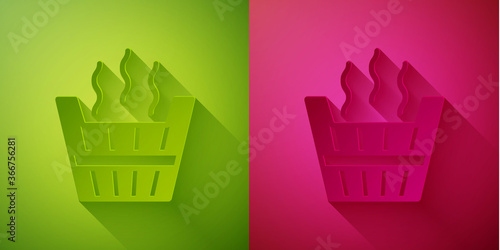 Paper cut Sauna bucket icon isolated on green and pink background. Paper art style. Vector.