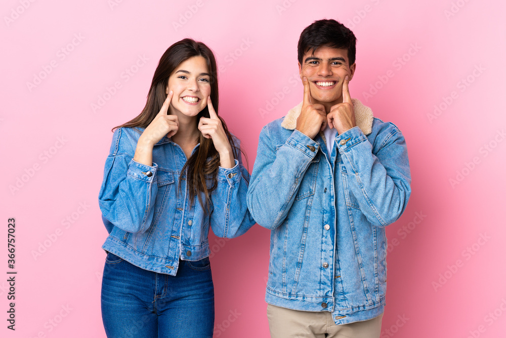 Young couple over isolated pink background smiling with a happy and pleasant expression Young couple over isolated pink background smiling with a happy and pleasant expression