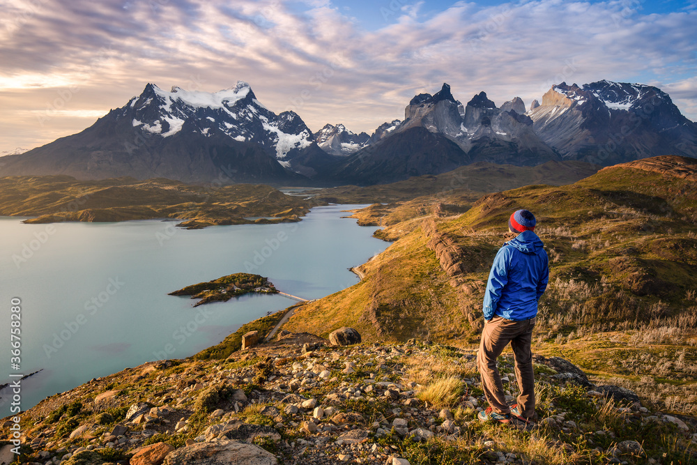 Solo traveler relaxing and meditating in front of the patagonian mountains and lakes.
Freedom lifestyle of an hiker immersed in nature. Chile