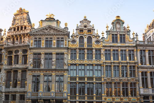 View of the richly decorated facades of the historic guildhouses in Grand Place at Sunset. Brussels, Belgium.