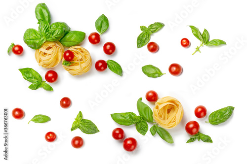 Fototapeta Naklejka Na Ścianę i Meble -  Cherry tomatoes, pasta and basil leaves on a white isolated background. Flat lay, copy space. Gamedients for dinner.