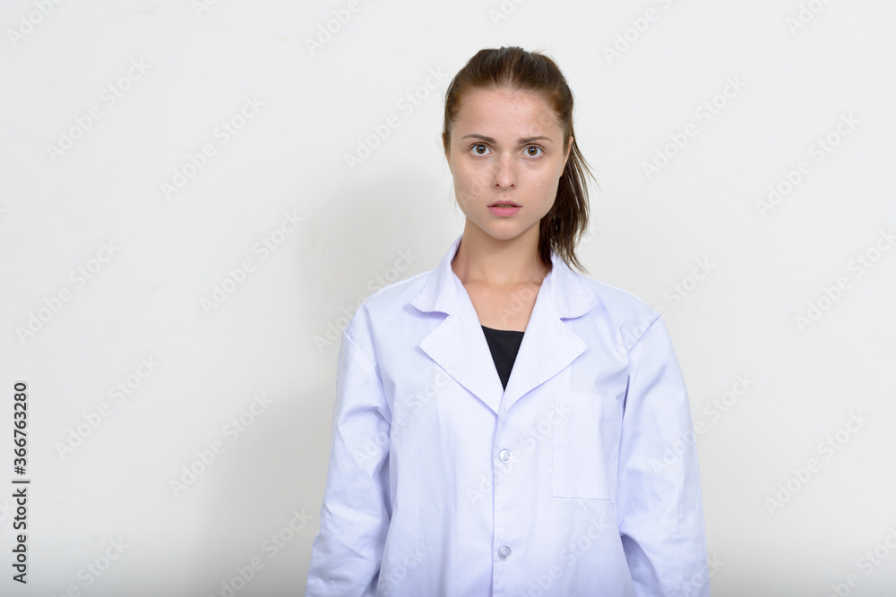 Portrait of young beautiful woman doctor against white background Portrait of young beautiful woman doctor against white background