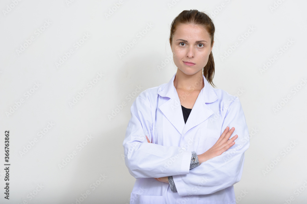 Portrait of young beautiful woman doctor against white background Portrait of young beautiful woman doctor against white background