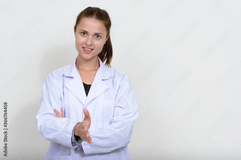 Portrait of young beautiful woman doctor against white background Portrait of young beautiful woman doctor against white background