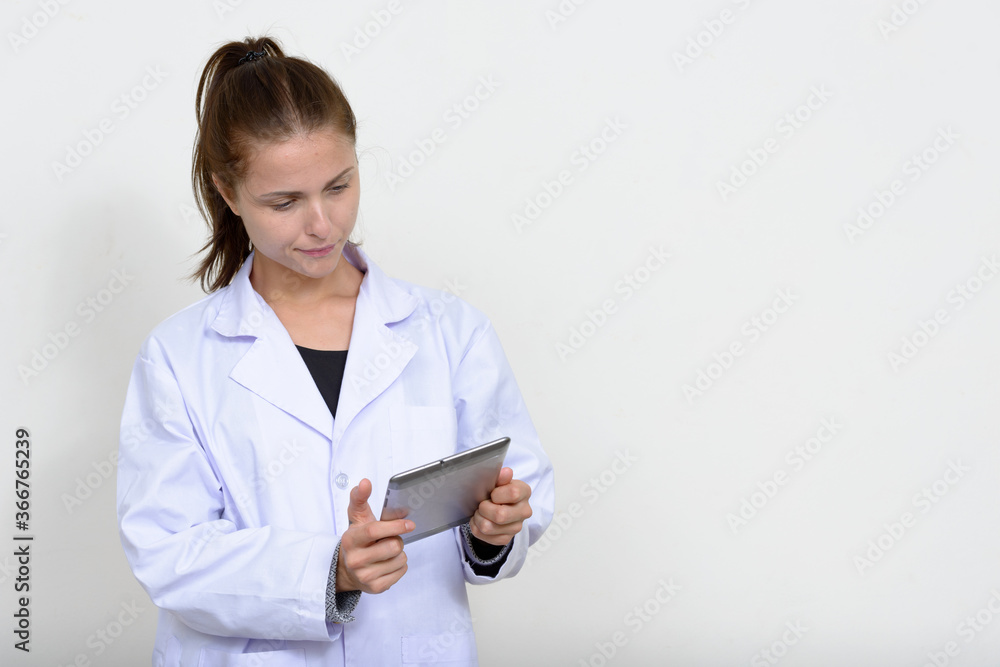 Portrait of young beautiful woman doctor against white background Portrait of young beautiful woman doctor against white background