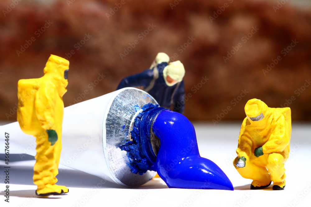 Miniature figure people wearing hazmat suits investigating a paint