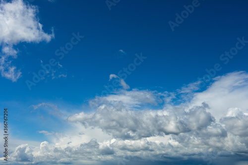 Beautiful blue sky background at daylight with white cumulus clouds.