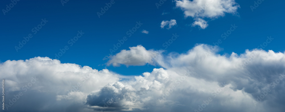 Beautiful blue sky background at daylight with white cumulus clouds. Backgroud panoramic banner. Beautiful blue sky background at daylight with white cumulus clouds. Backgroud panoramic banner.