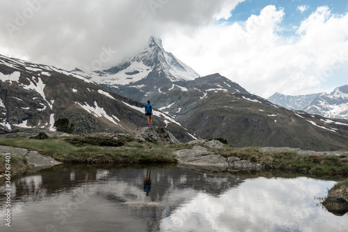 Trail runner woman running with scenic view of Matterhorn mountain in the Swiss Alps